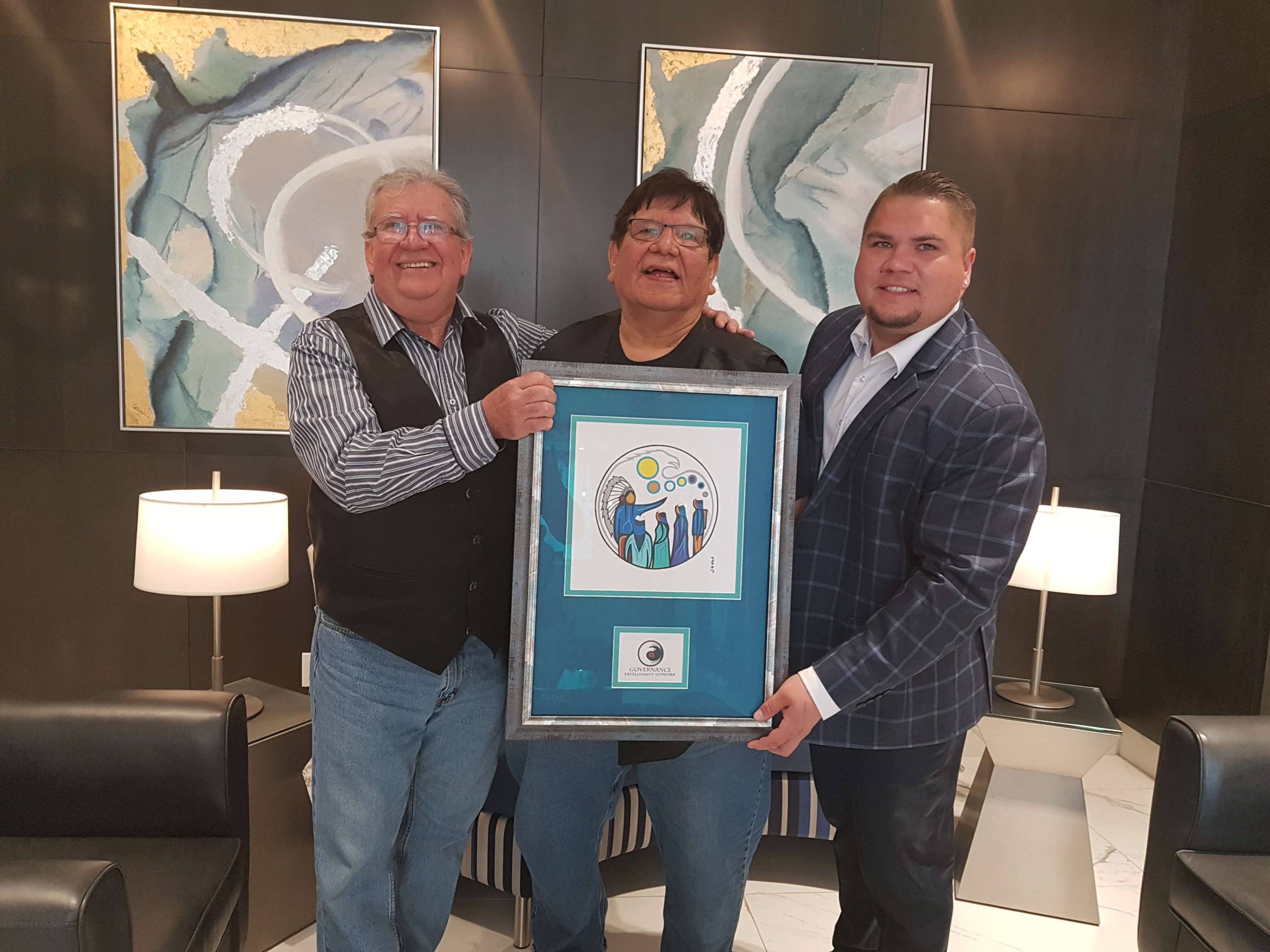 Harry Willmot accepting an Award from Chief Tom Bressette and Mathew Laine, from the Governance Development Network.